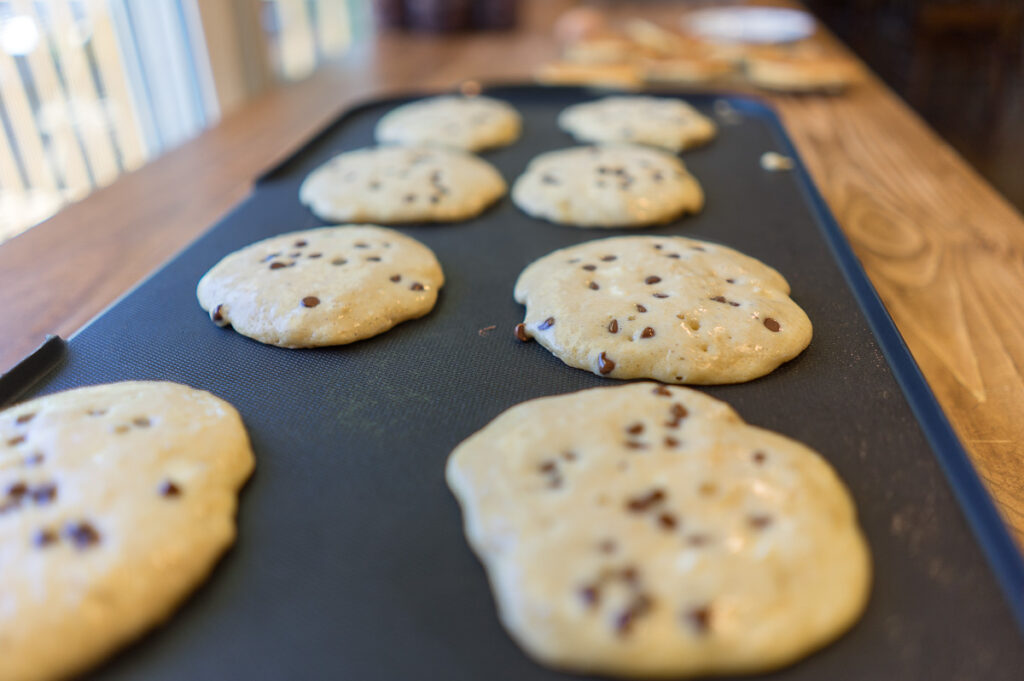  fresh-milled sourdough protein pancakes cooking on griddle
